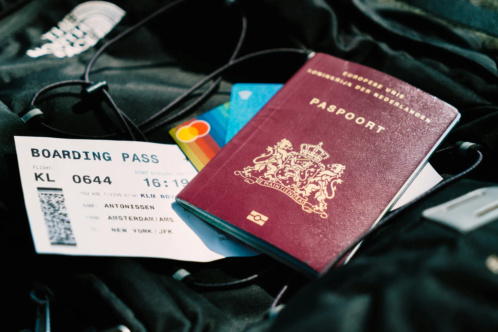 Dutch passport and boarding pass on travel luggage